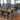 Dark brown chairs at long rectangle light brown tables in an event room