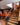 Staircase leading to an upper level with a bar area and seating in the background.