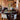 Dining area with rustic decor, including a wooden table and cowhide chairs.