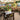 Covered outdoor garden area with bar tables and dining tables