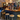 A mix of wooden top and fabric topped stools around a bar