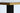Close-up of a gold and black rectangular table top with a white background