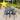 4 black plastic chairs around a black metal square table in a garden