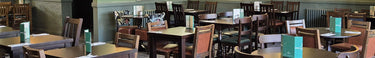 A newly refurbished restaurant with dark brown chairs and tables 
