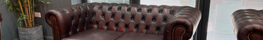 An antique red Chesterfield style sofa