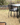 Multiple metal garden tables each with four chairs