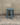Blue stool against a concrete wall