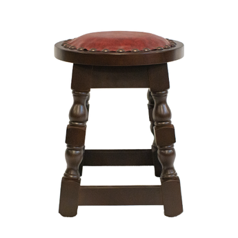 Wooden stool with a red leather seat on a white background