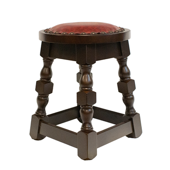 Wooden stool with a red leather seat on a white background