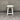 White stool against a gray concrete wall