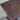 Scratched brown surface with metal screws on a concrete floor