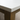 Close-up of a corner where a white top meets a wooden base on a neutral background