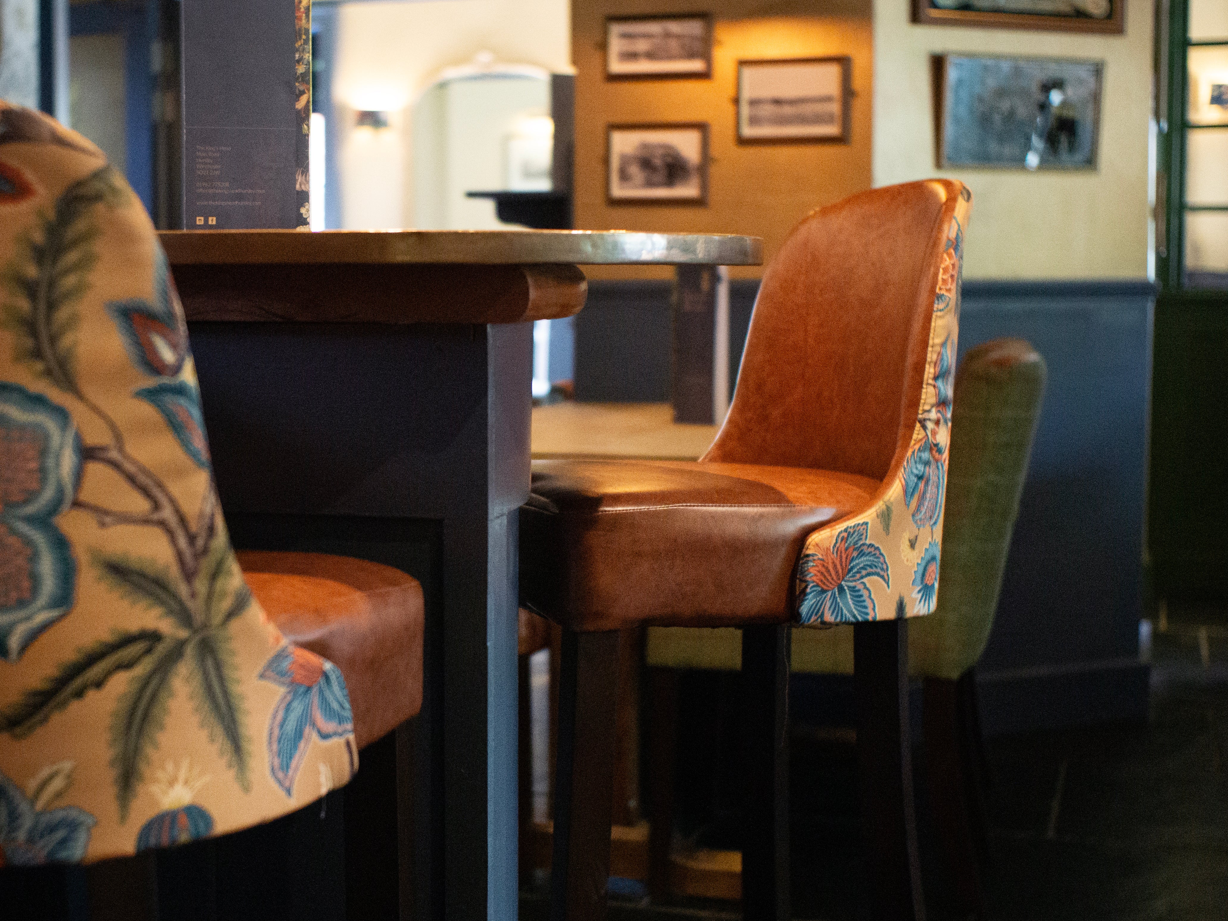 Yellow floral Kenilworth bar chairs with a tan vinyl inner
