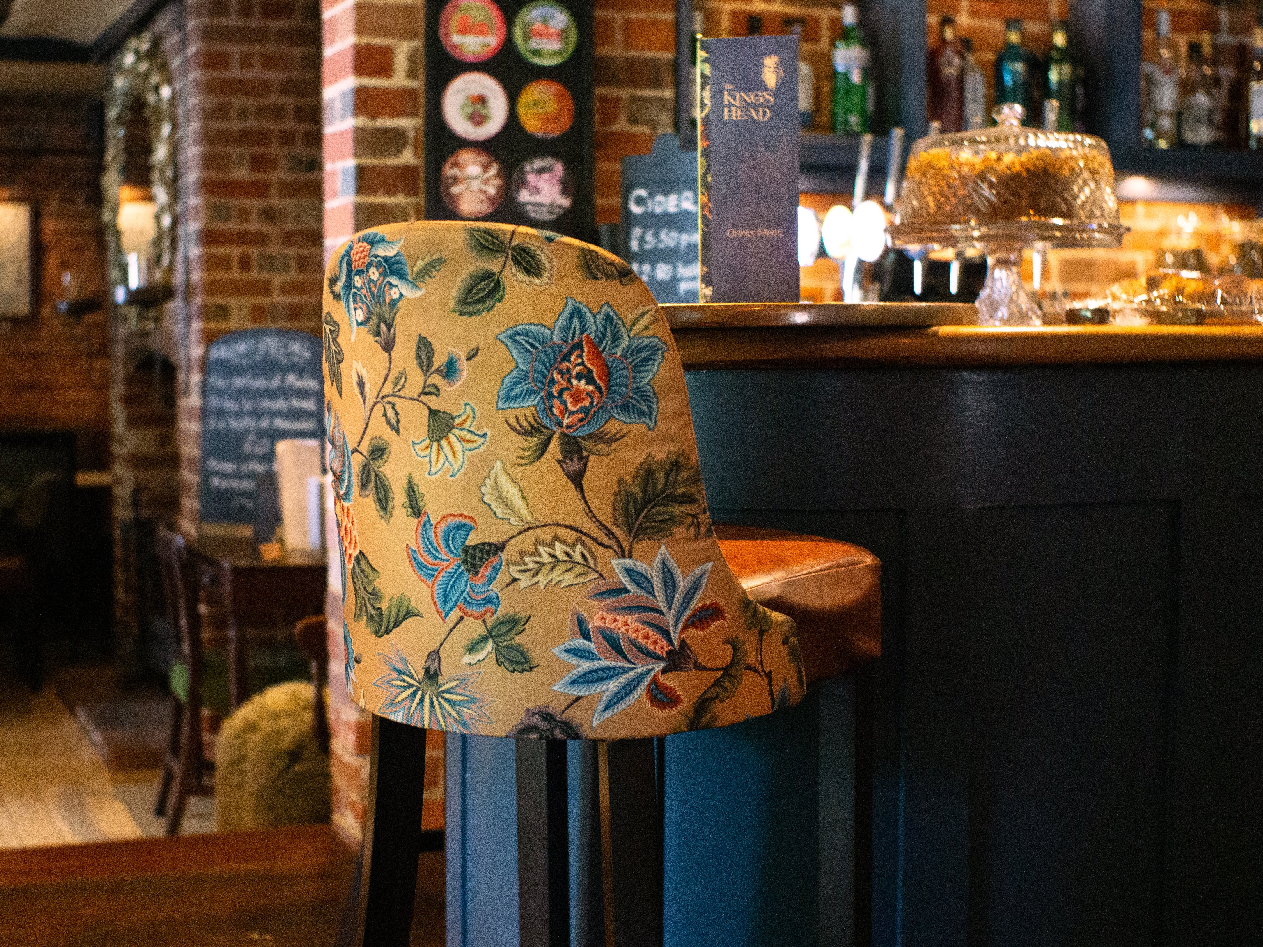 Yellow floral bar chair at a bar