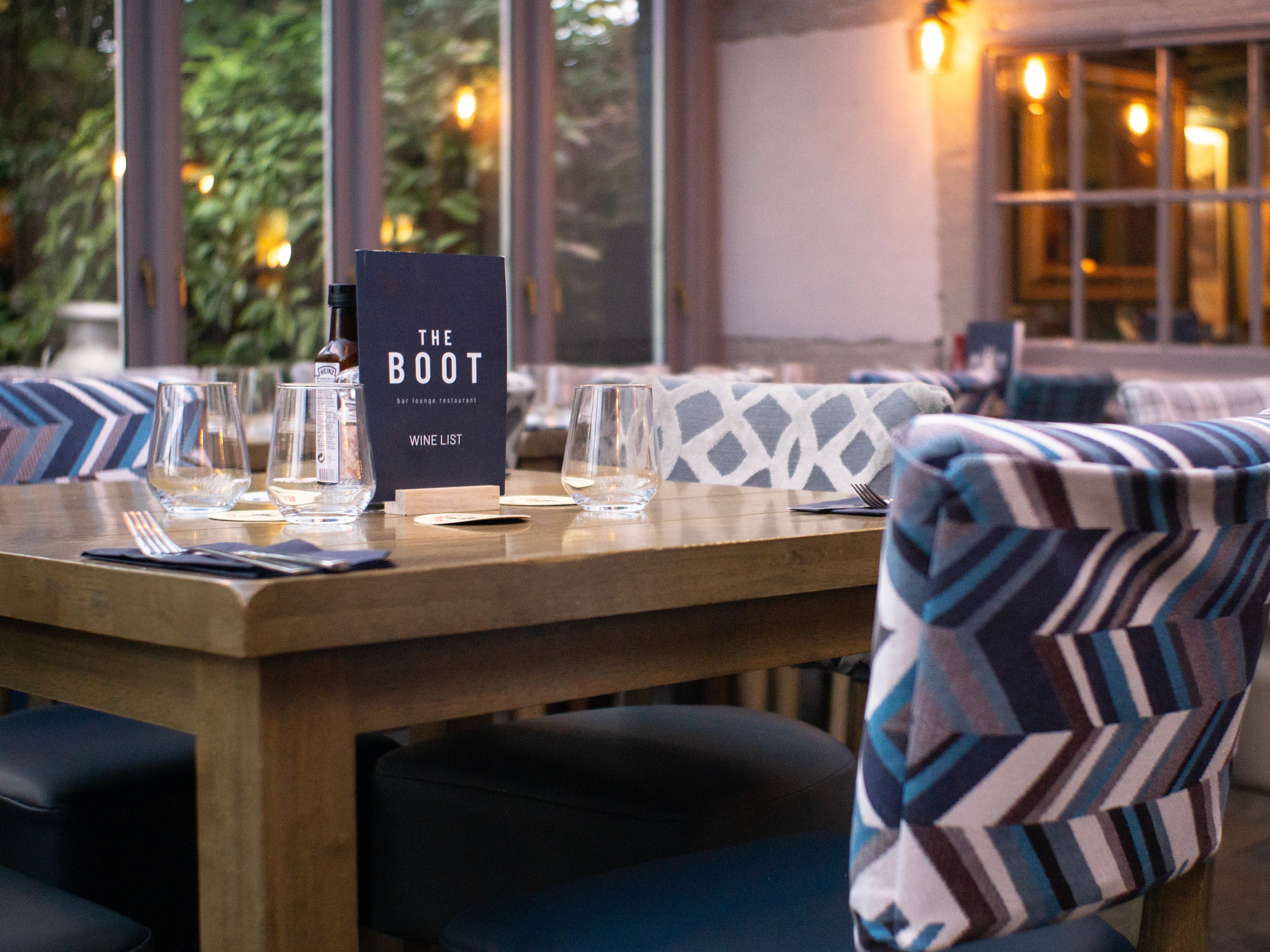 Restaurant with Luigi dining chairs, chunky wooden square dining tables and farmhouse tables