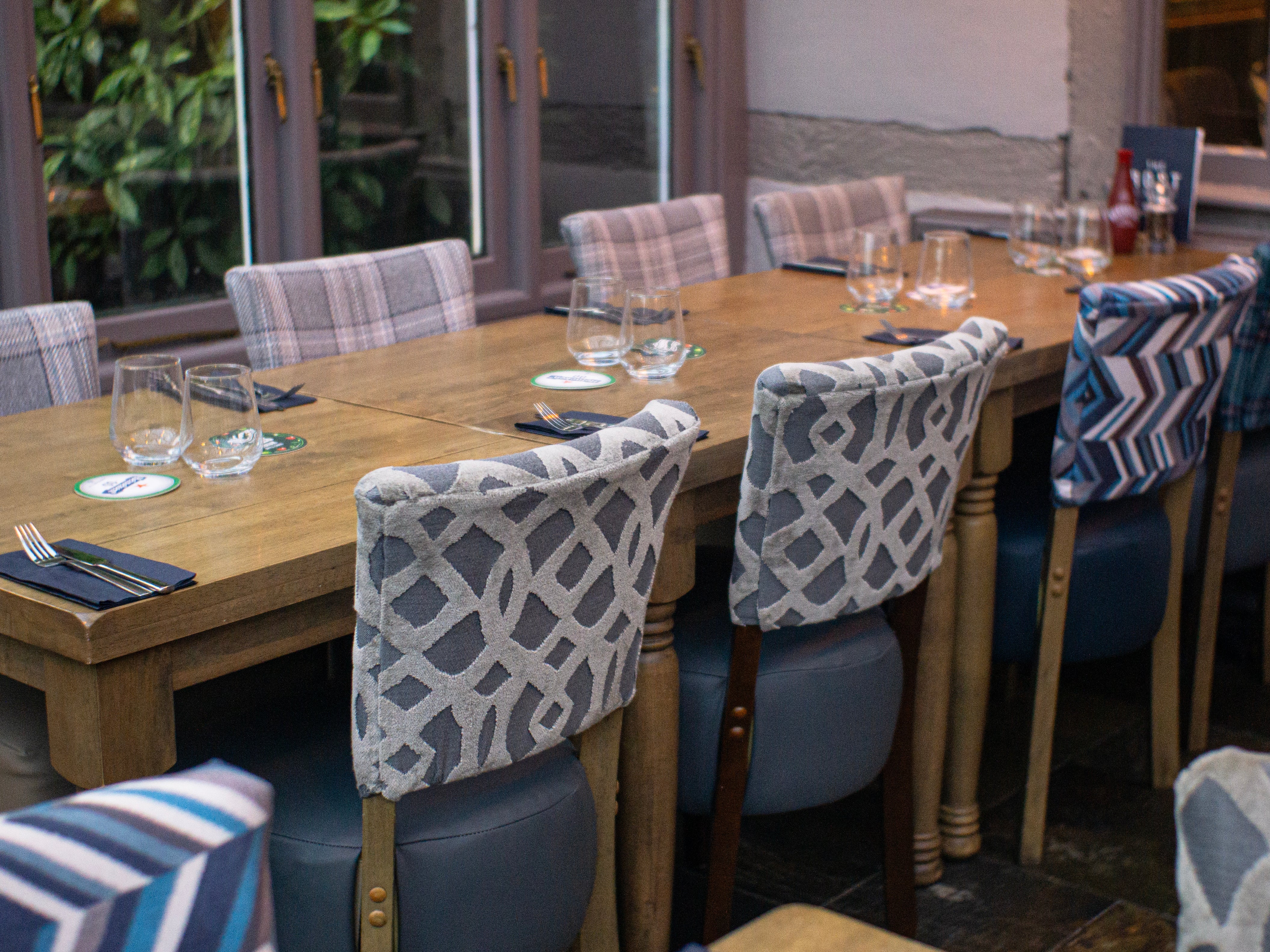 Restaurant with Luigi dining chairs, chunky wooden square dining tables and farmhouse tables