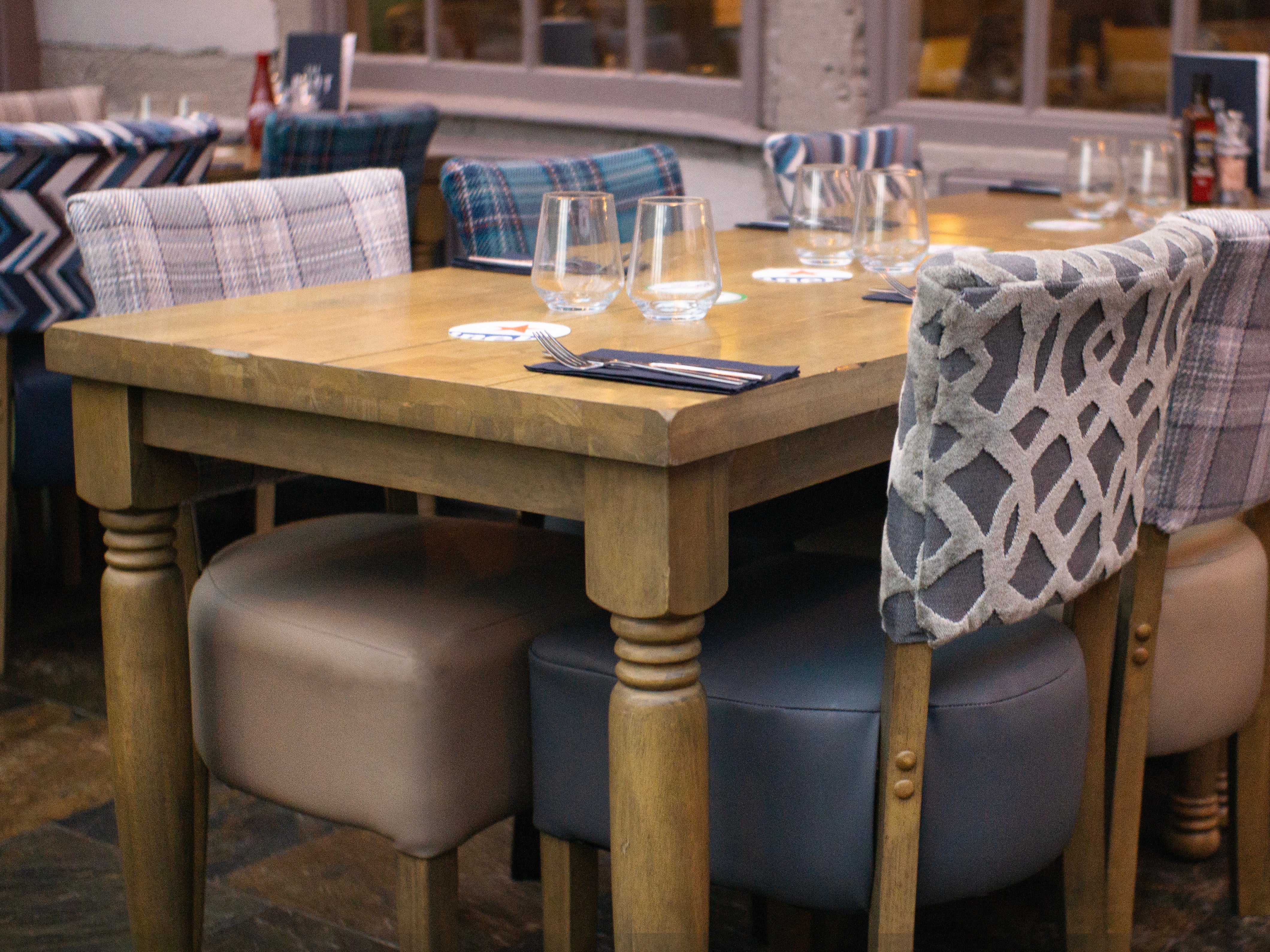Restaurant with Luigi dining chairs, chunky wooden square dining tables and farmhouse tables
