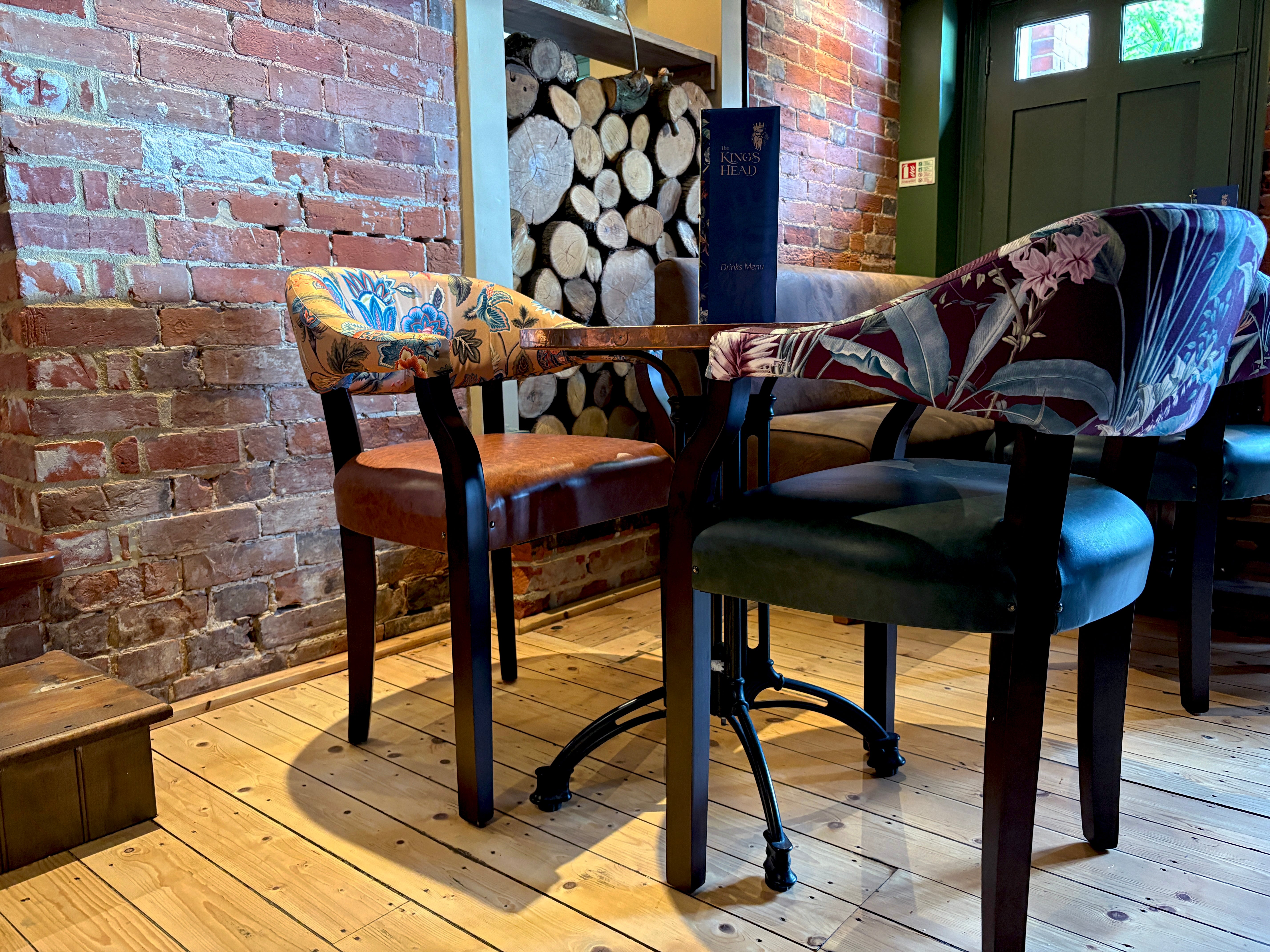 Two Hereford carver chairs around a metal based table