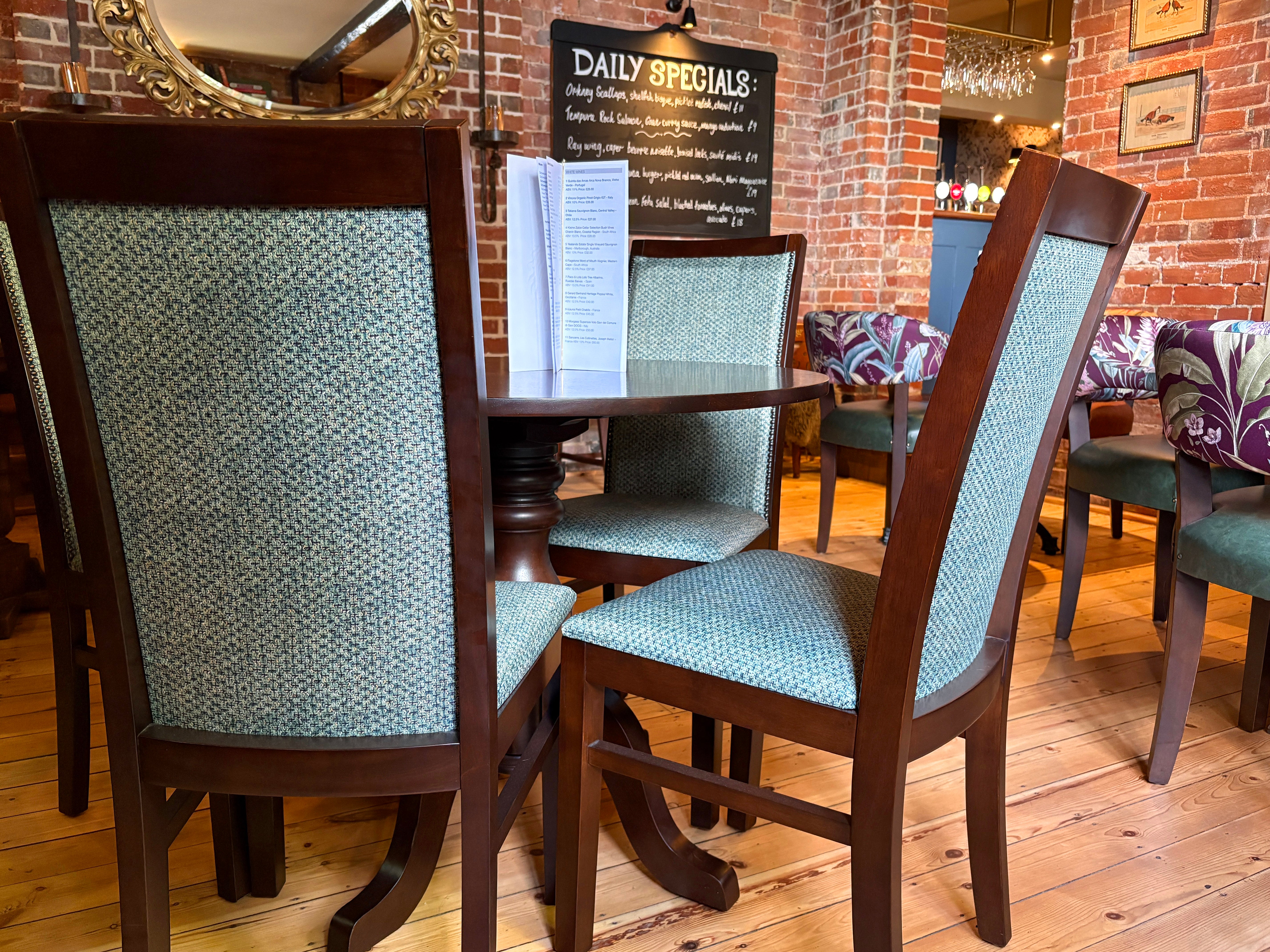 Dark brown Modena chairs iin a dining room with blue fabric