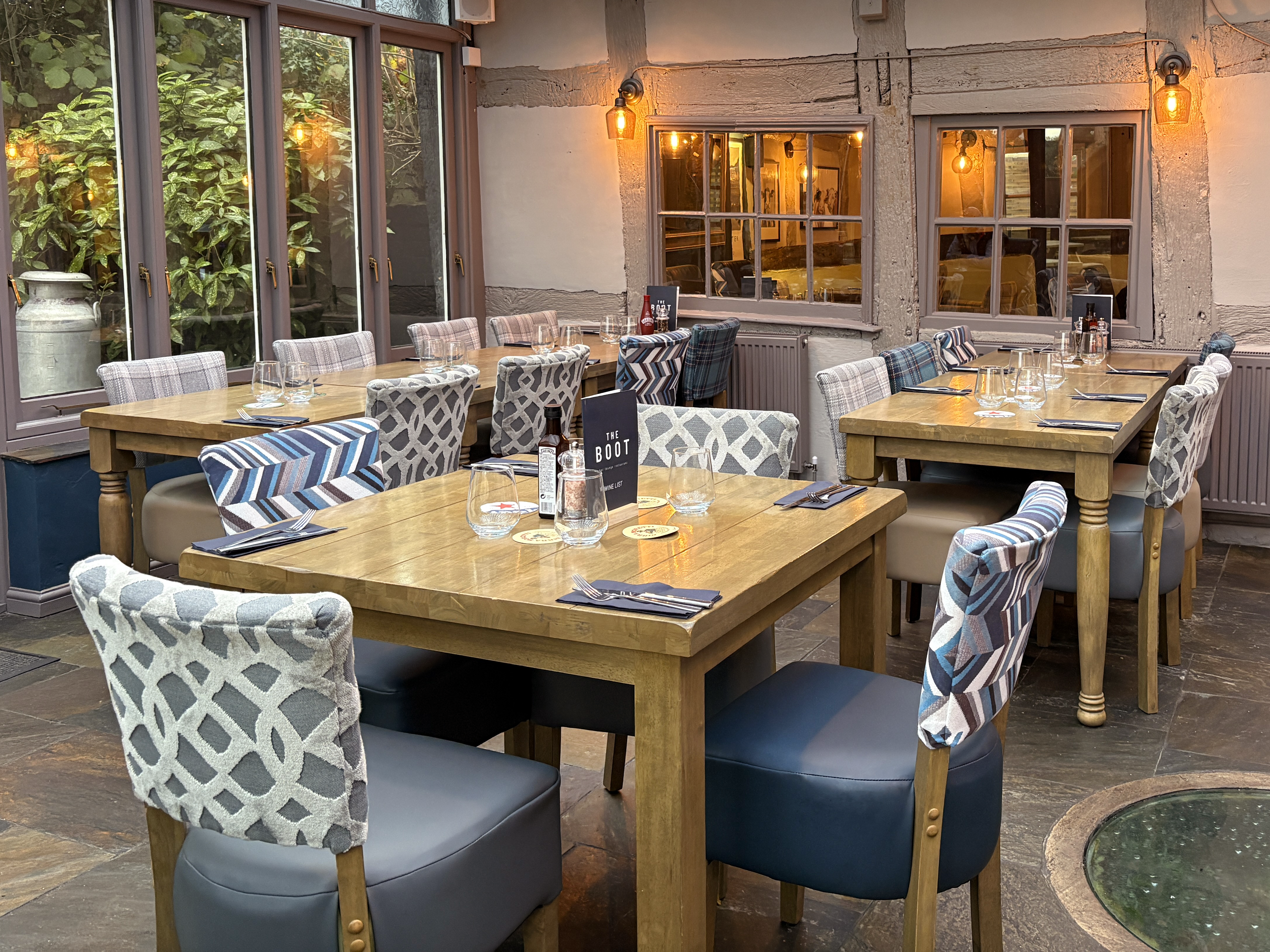 Restaurant with Luigi dining chairs, chunky wooden square dining tables and farmhouse tables