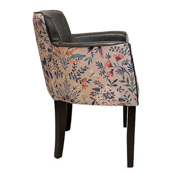 Chair with floral patterned backrest and black leather armrests on a white background